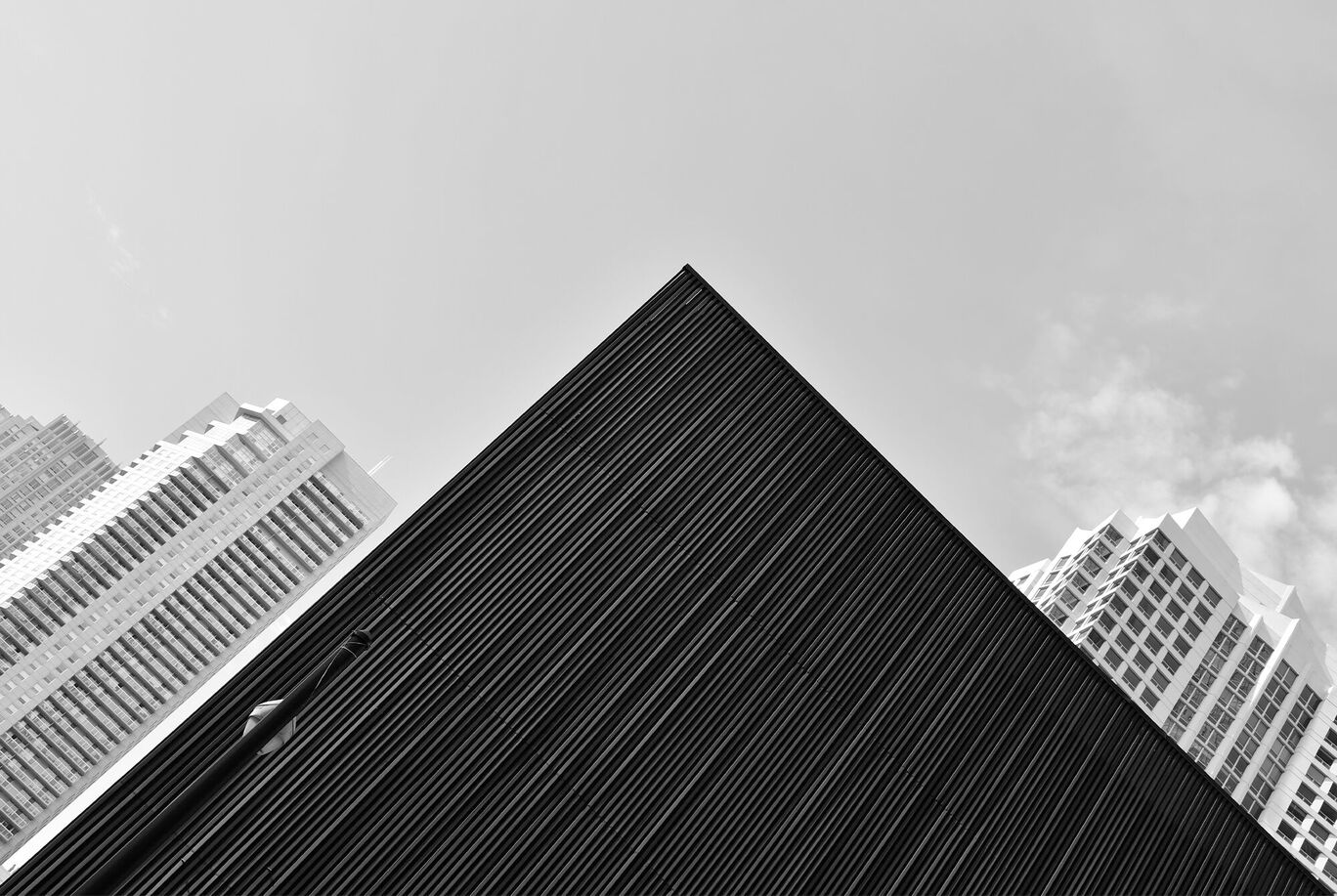 Schwarze Gebäudefassade im Hochformat mit wolkenlosem Himmel