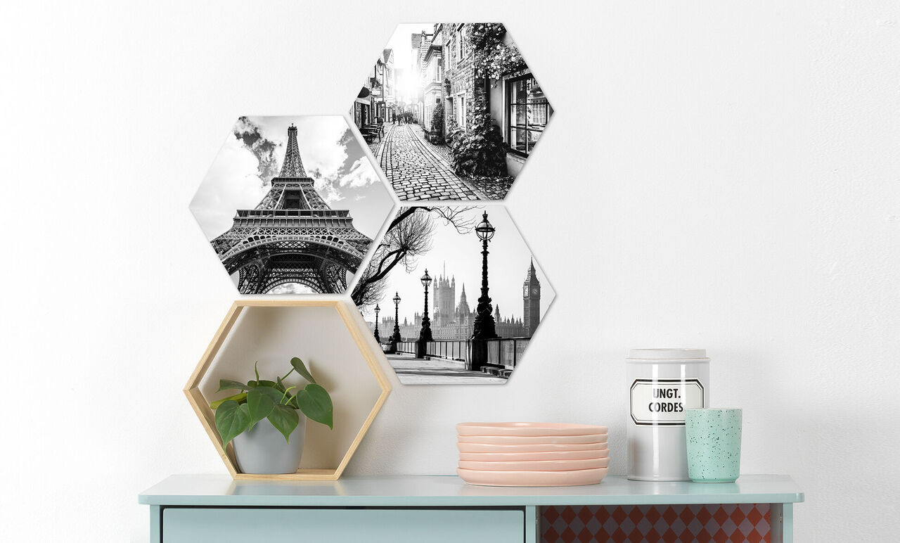 Drei hexagonale Bilder in schwarz-weiß mit den Sehenswürdigkeiten Eiffel Turm, Londoner Skyline und einer Stadtstraße