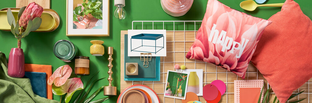 Bunte Collage mit Deko-Elementen und Bildern auf einer Holzfläche