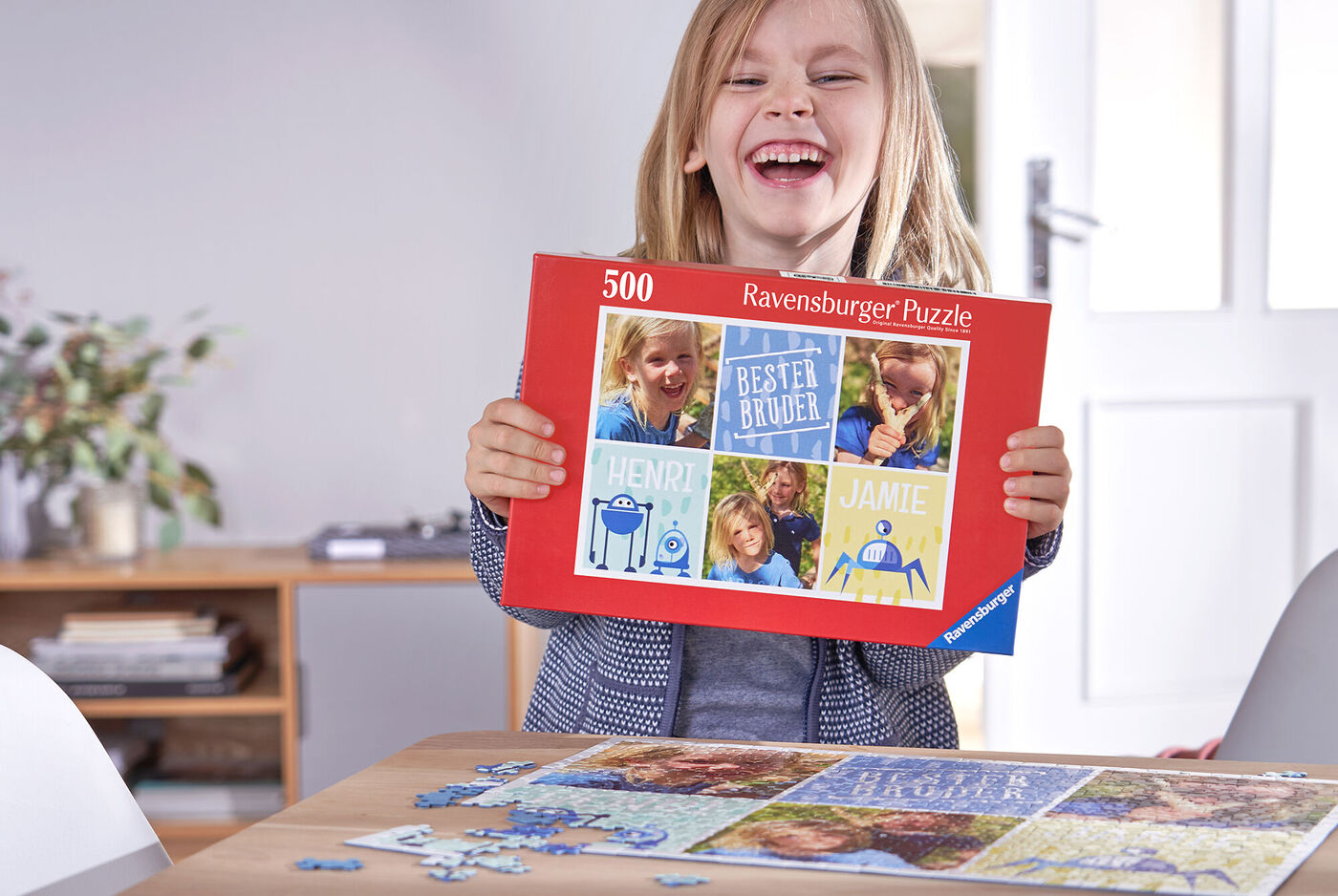 Ein Kind hält ein Puzzle mit dem Titel "Bester Bruder" und lächelt dabei
