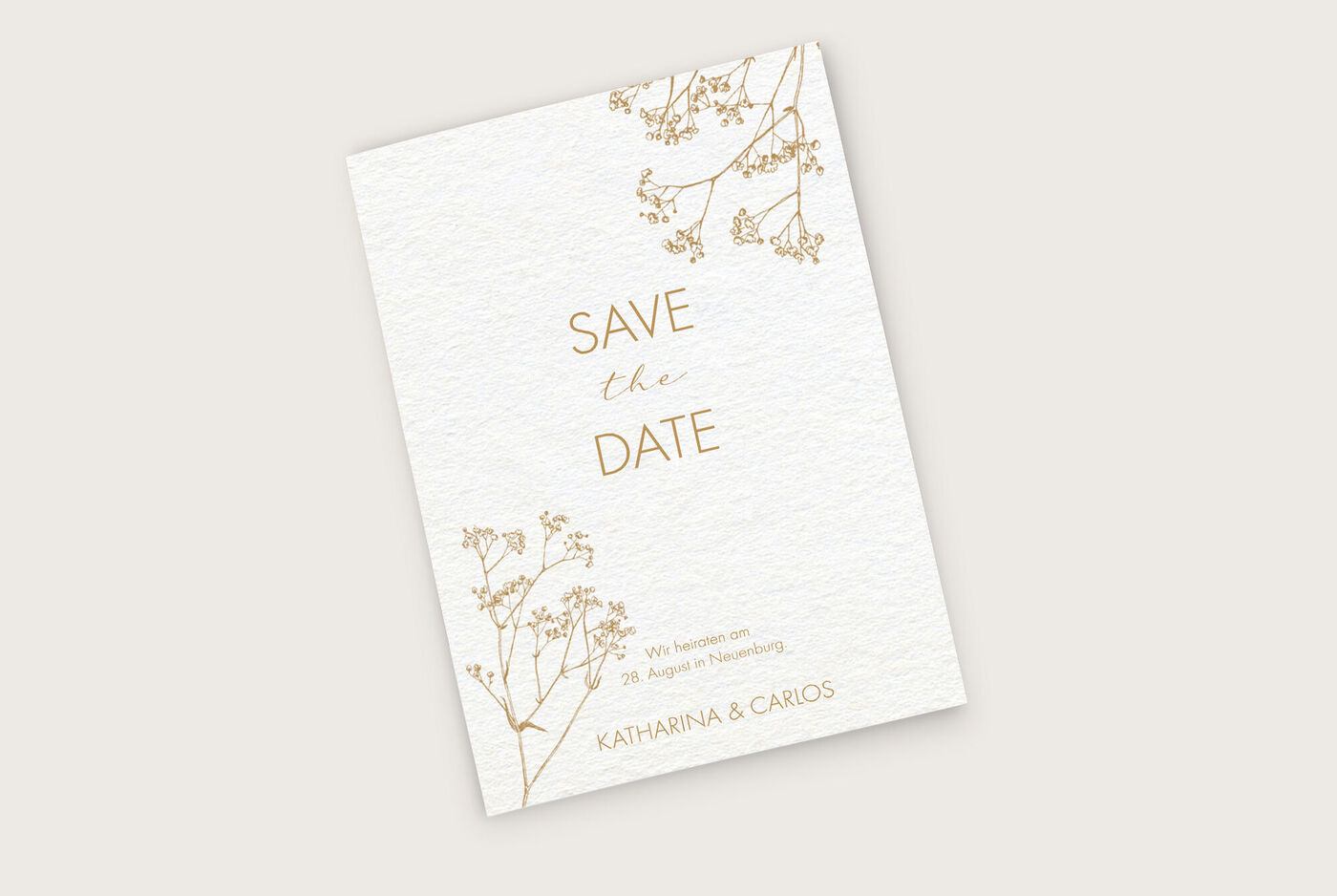 Eine elegante Hochzeitskarte mit goldenen Akzenten und zarten floralen Motiven.