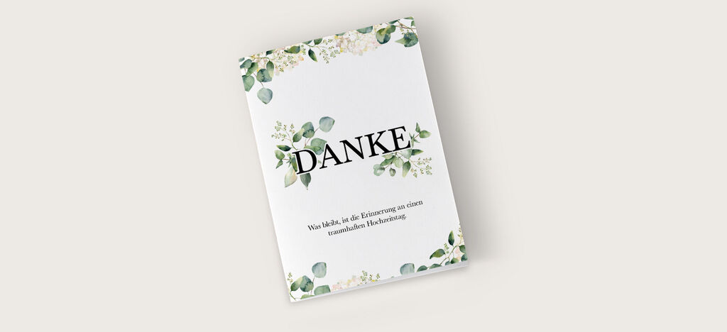 Eine liebevoll gestaltete Dankeskarte mit floralen Elementen in Grün und Weiß.