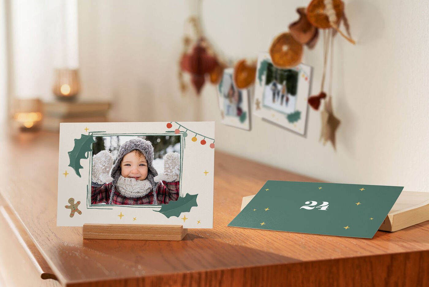 Eine festliche Weihnachtskarte mit einem Foto. Die Karte ist liebevoll dekoriert mit bunten Weihnachtsmotiven. Im Hintergrund sind weitere Weihnachtskarten sichtbar, die eine winterliche Stimmung vermitteln