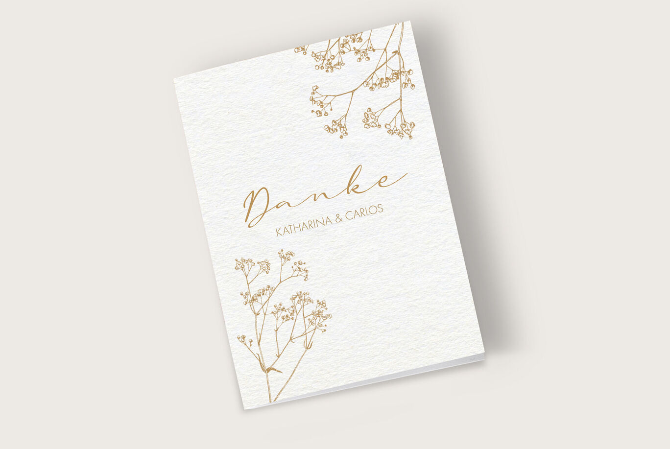 Dankeskarte mit zarten Blumenmotiven in Gold und Schriftzug 'Danke'