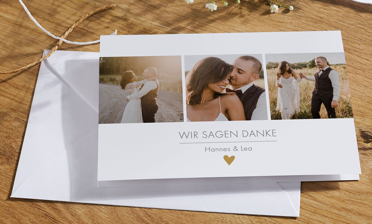 Eine stilvolle Dankeskarte in weiß mit drei Fotos. Mit der Aufschrift 'Wir sagen Danke' und den Namen Hannes und Lea.