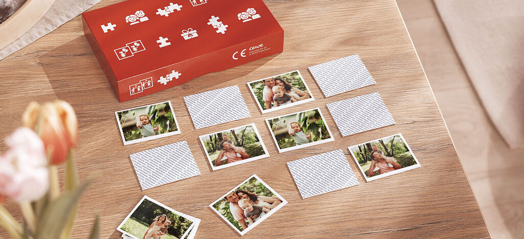 Zehn personalisierte Foto-Memory-Karten auf einem Holztisch, rot verpackt