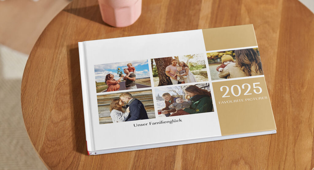 Ein CEWE Fotobuch auf einem Tisch zeigt Fotos von Familie und Freunden. Es ist liebevoll gestaltet und präsentiert wunderbare Erinnerungen aus 2024.