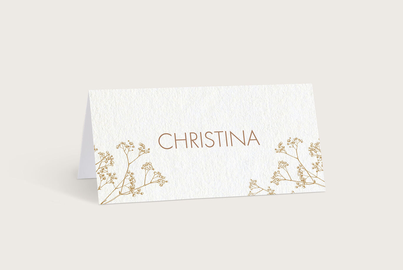Elegante Platzkarte mit goldenem Schriftzug "Christina" und zarten Pflanzenmotiven für festliche Anlässe