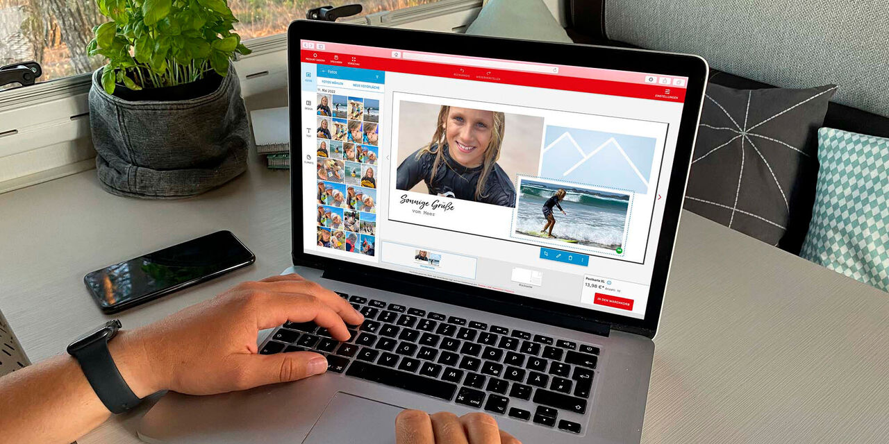 Person gestaltet mit Begeisterung eine CEWE Grußkarte auf einem Laptop.