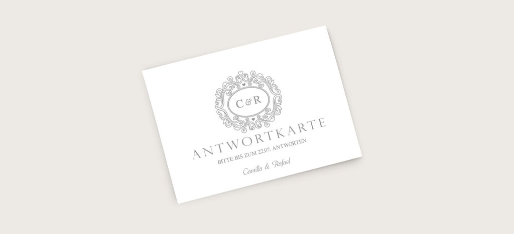Elegante Antwortkarte mit dem Schriftzug "ANTWORTKARTE" und einem geschwungenen Rahmen in Grau.