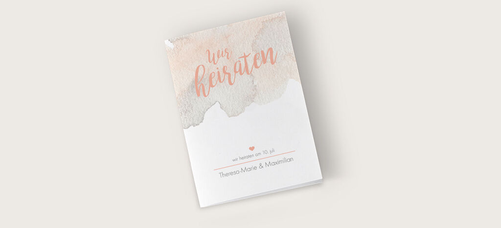 Ein wunderschön gestaltetes Hochzeitsalbum mit zarten Aquarellfarben und dem Titel 'Wir heiraten'.