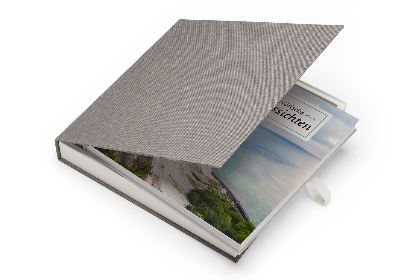 Ein schickes CEWE FOTOBUCH mit grauem Stoffeinband und Sichtfenster zeigt eine bunten Landschaftsaufnahme.