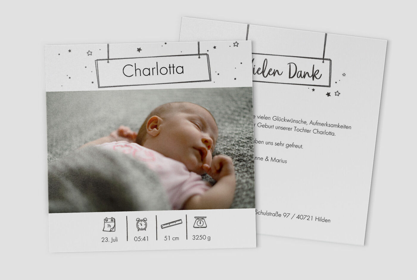 Eine schlafende Babymädchen Charlotta, umgeben von Glückwünschen zur Geburt.
