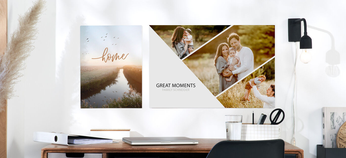 Wandbilder mit der Aufschrift 'home' und 'great moments' an einer Wand über einem Schreibtisch.